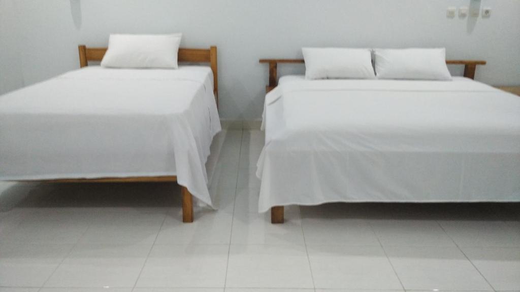 Postel nebo postele na pokoji v ubytování Pondok Siola