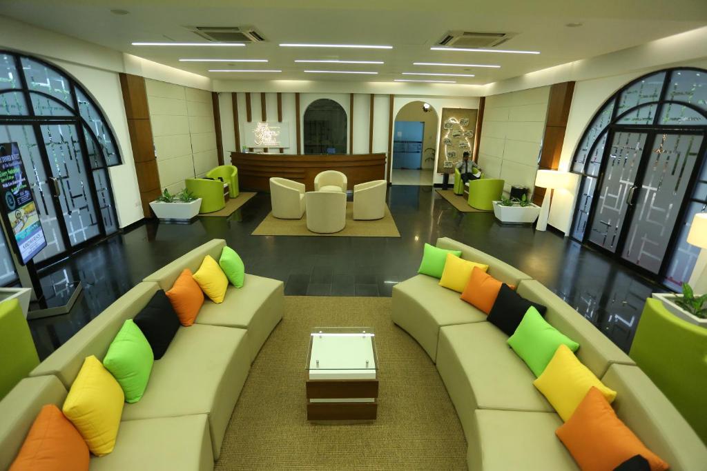 a lobby with a couch and chairs and a table at Kandyan Reach Hotel in Kurunegala