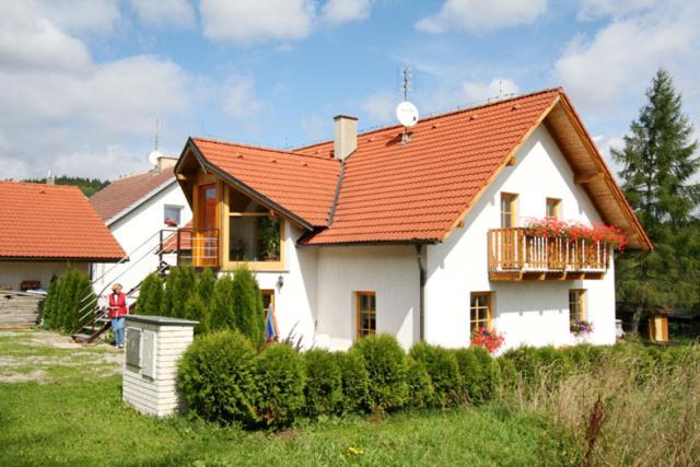 mały biały dom z pomarańczowym dachem w obiekcie Apartment Veronika w mieście Přední Výtoň