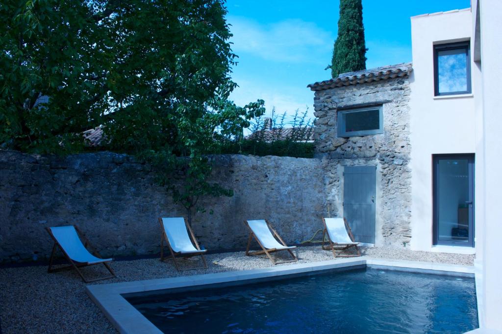 a group of chairs sitting next to a swimming pool at My Home in lourmarin in Lourmarin