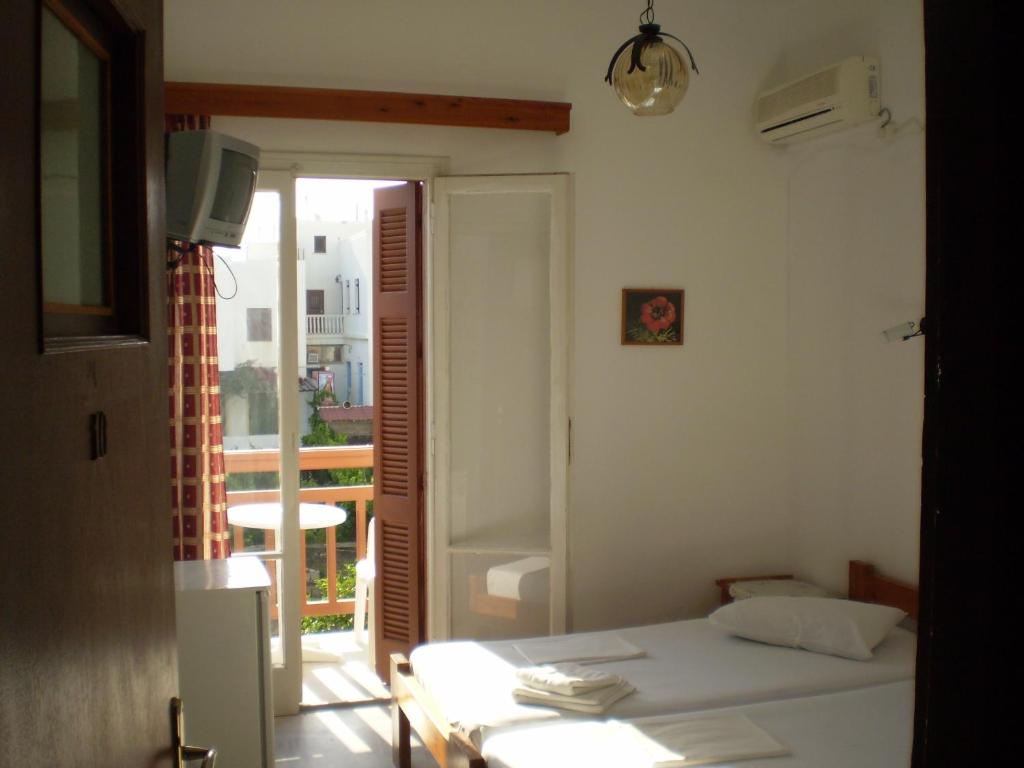 Postel nebo postele na pokoji v ubytování Hotel Maroulis