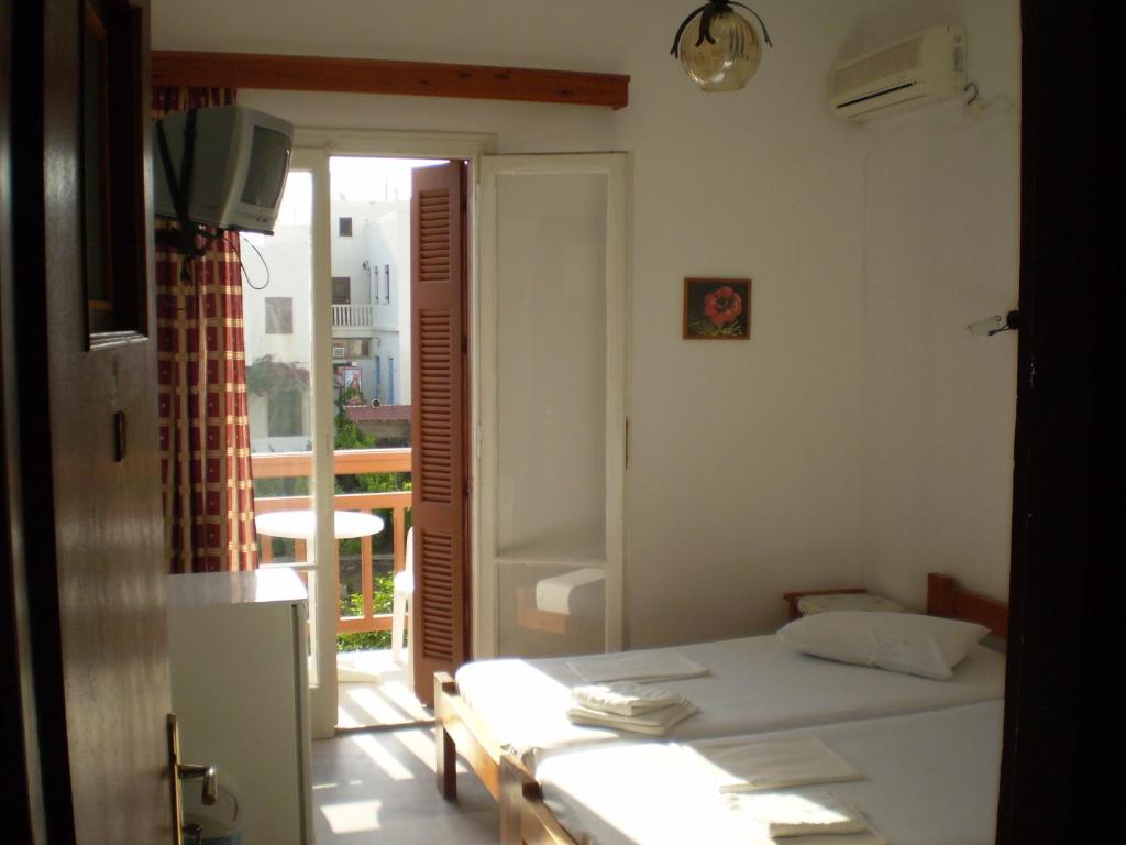 Postel nebo postele na pokoji v ubytování Hotel Maroulis