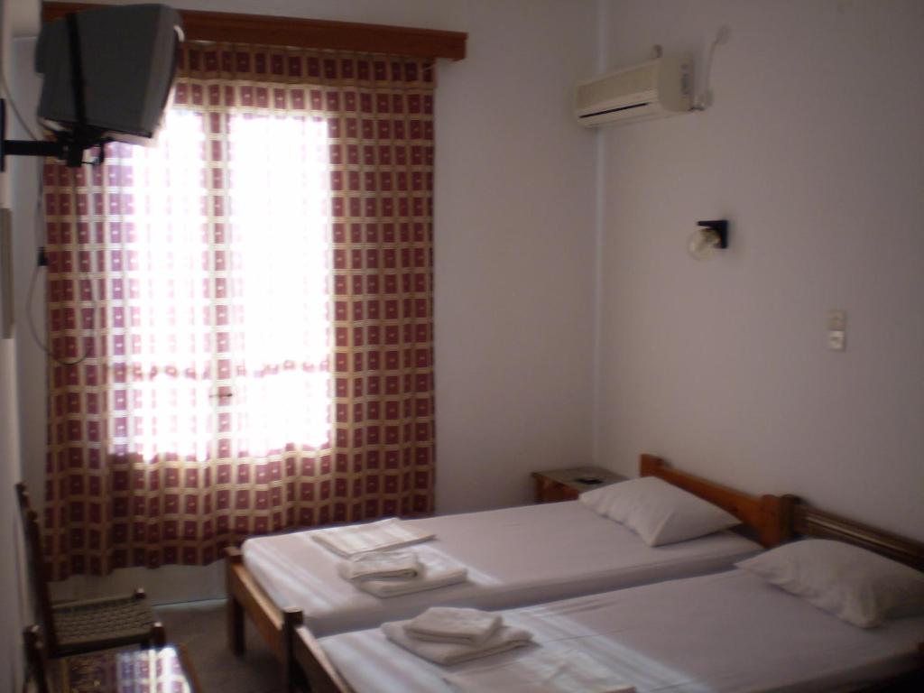 Postel nebo postele na pokoji v ubytování Hotel Maroulis