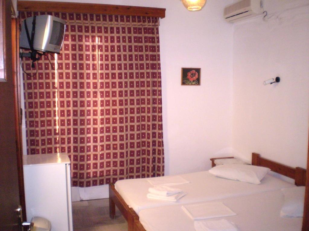 Postel nebo postele na pokoji v ubytování Hotel Maroulis