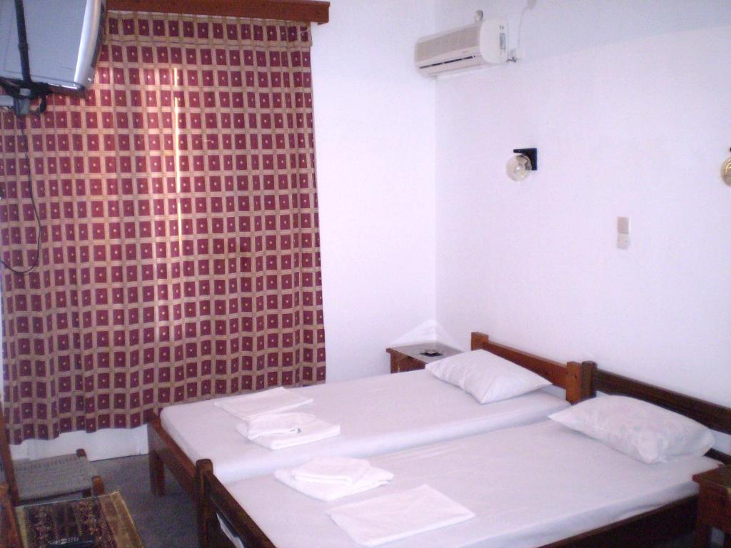 Postel nebo postele na pokoji v ubytování Hotel Maroulis
