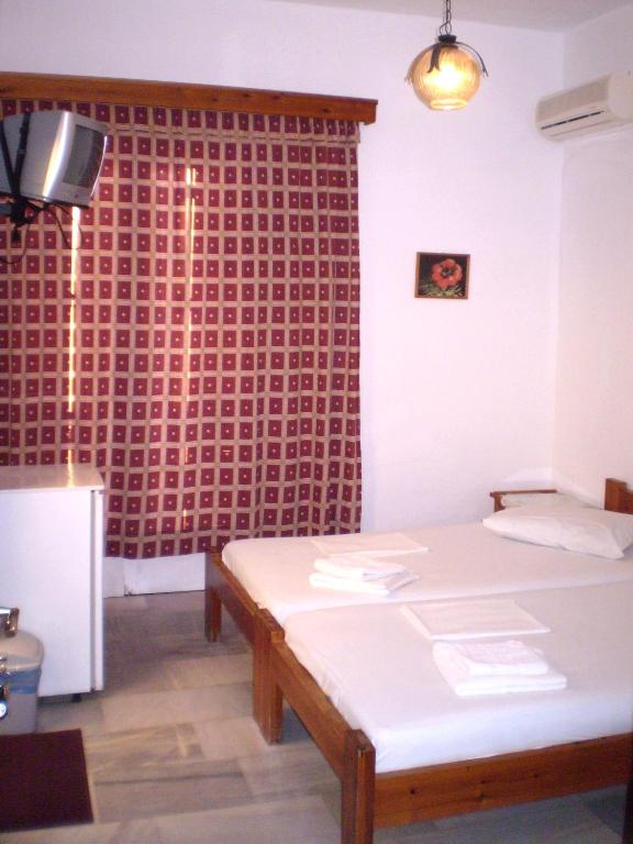 Postel nebo postele na pokoji v ubytování Hotel Maroulis