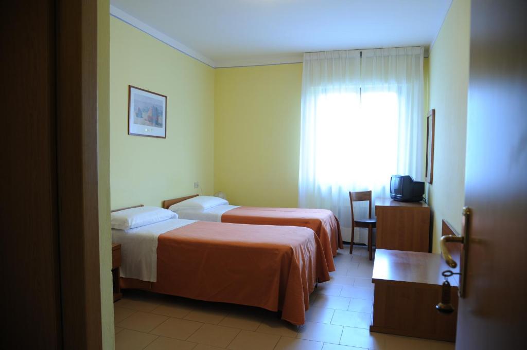 A bed or beds in a room at Hotel Tre Castelli