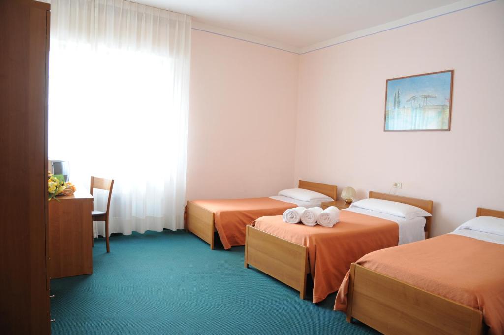 A bed or beds in a room at Hotel Tre Castelli