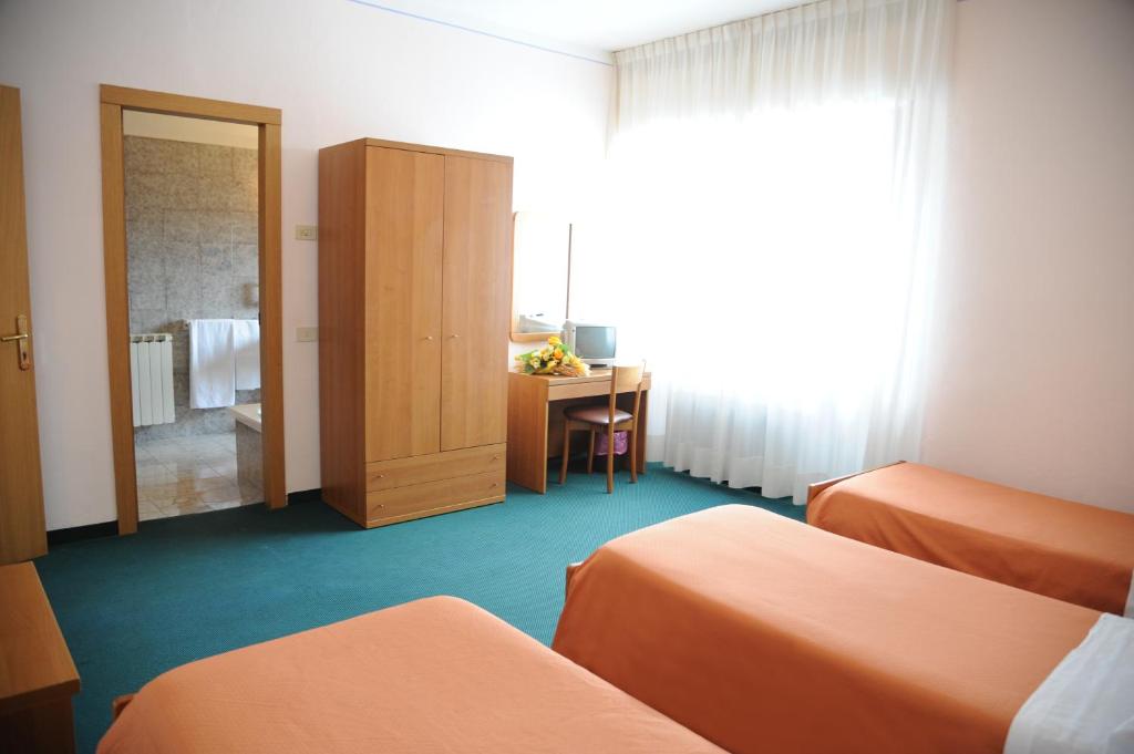 A bed or beds in a room at Hotel Tre Castelli