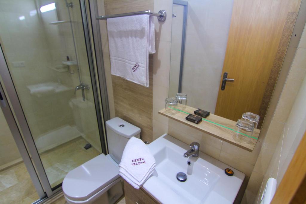 a bathroom with a toilet and a sink and a shower at Hotel Kenzo in Safi