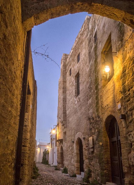 an alley in an old town at night at Trinity Boutique Hotel in Rhodes Town