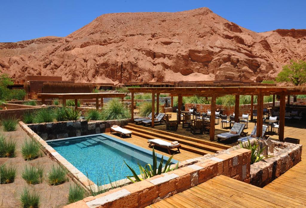 a resort with a swimming pool in the desert at Nayara Alto Atacama in San Pedro de Atacama
