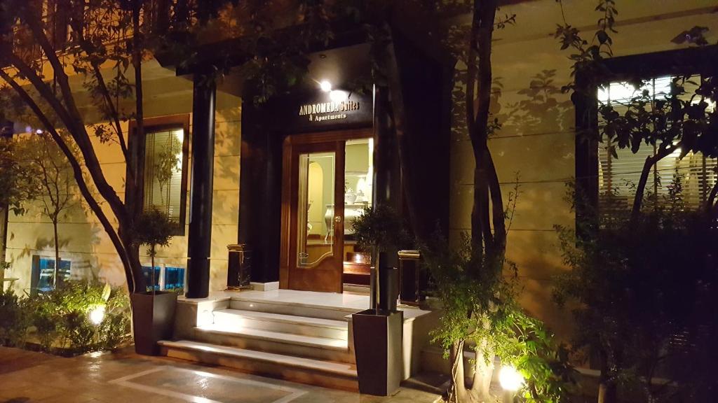 a house with stairs leading to a door at night at Andromeda Suites in Athens