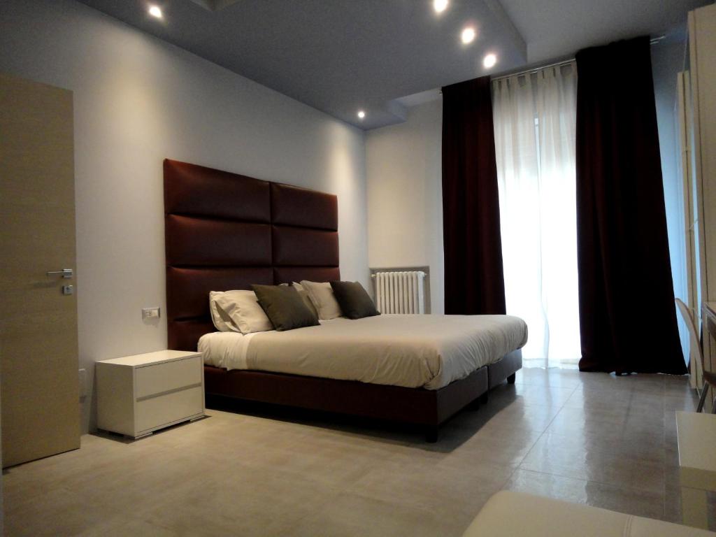 a bedroom with a large bed and a large window at The Flat 233 in Tavarnuzze