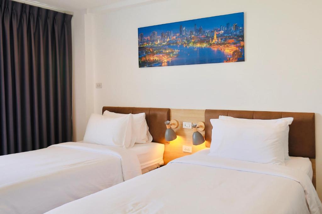 A twin room with two beds, individual bedside lights and blackout curtains.