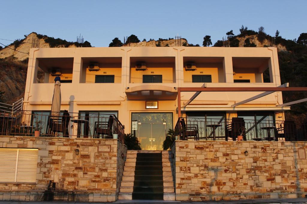 a building with a staircase in front of it at Θέα - View Appartments in Paralía Kímis