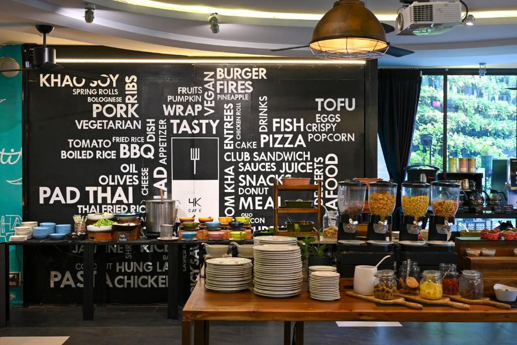 A restaurant buffet display backed by a large menu-style chalkboard.