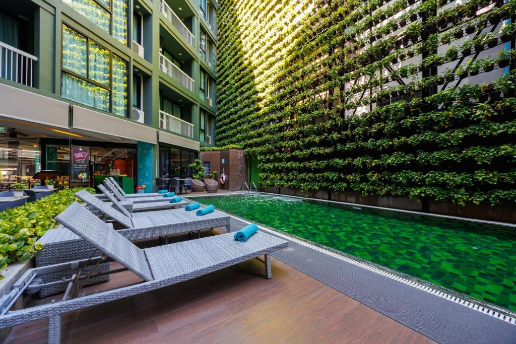 A landscaped courtyard pool lined with reclining loungers.