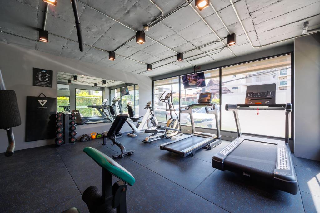A bright hotel gym with treadmills, bikes and free weights.