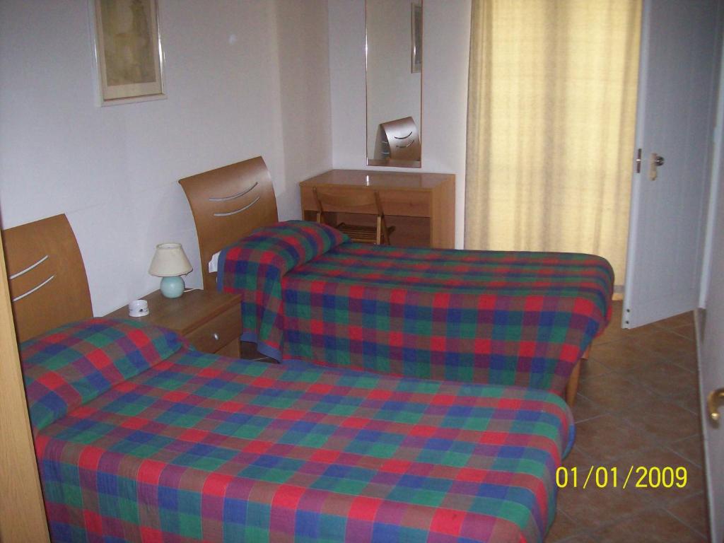 Postel nebo postele na pokoji v ubytování Albergo La Perla