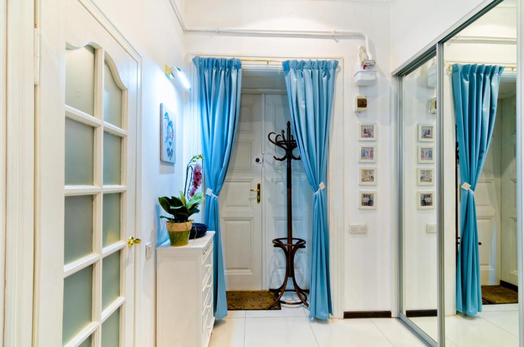 a hallway with blue curtains in a home at Stylish Studio near Rynok square in Lviv