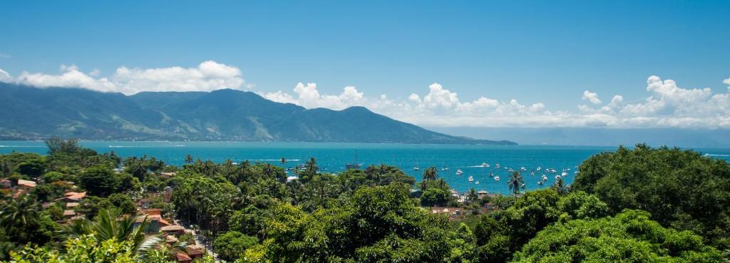 a view of the ocean with boats in the water at Pousada Mariola in Ilhabela