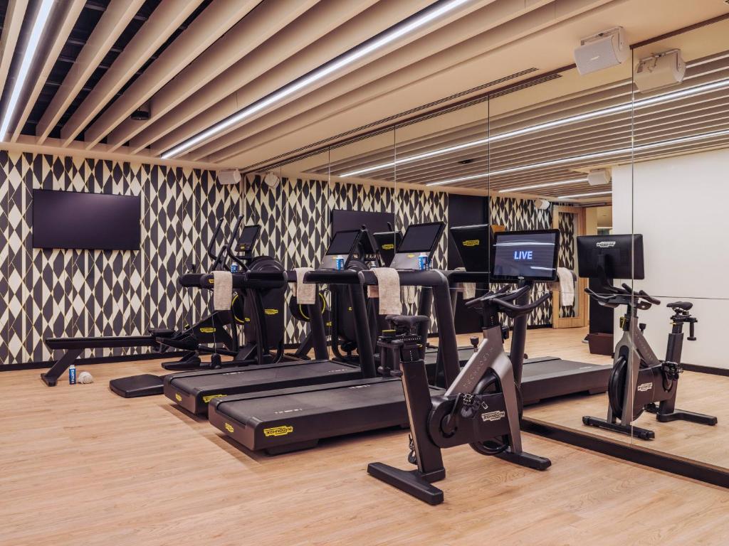 A compact, modern gym offers treadmills, ellipticals and stationary bikes.