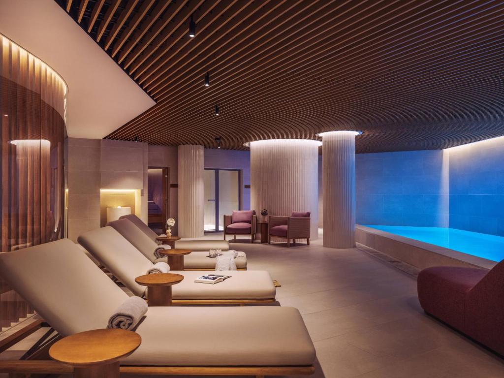 A softly lit spa lounge beside an indoor pool.