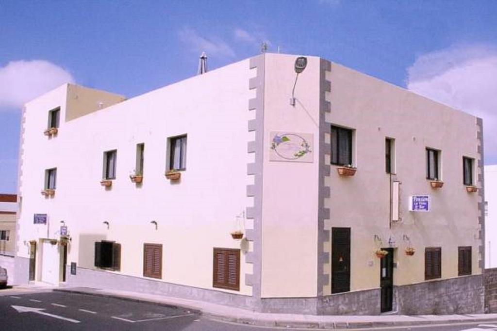 a large white building on the side of a street at La Vista Pension in Guía de Isora