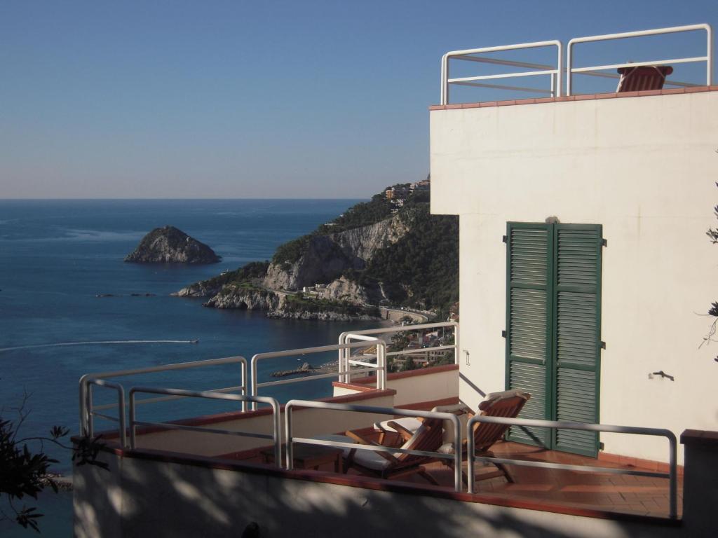 a balcony of a building with a view of the ocean at Hotel Claudio in Bergeggi