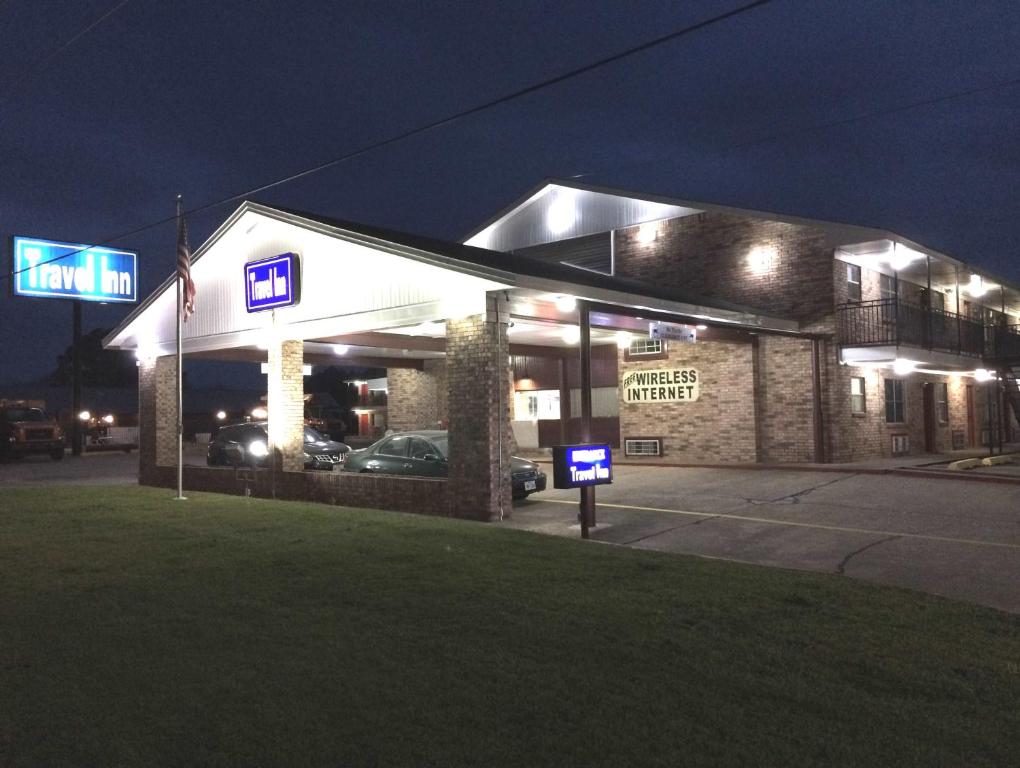 a building with a parking meter in front of it at night at Travel Inn & Suites in Atlanta
