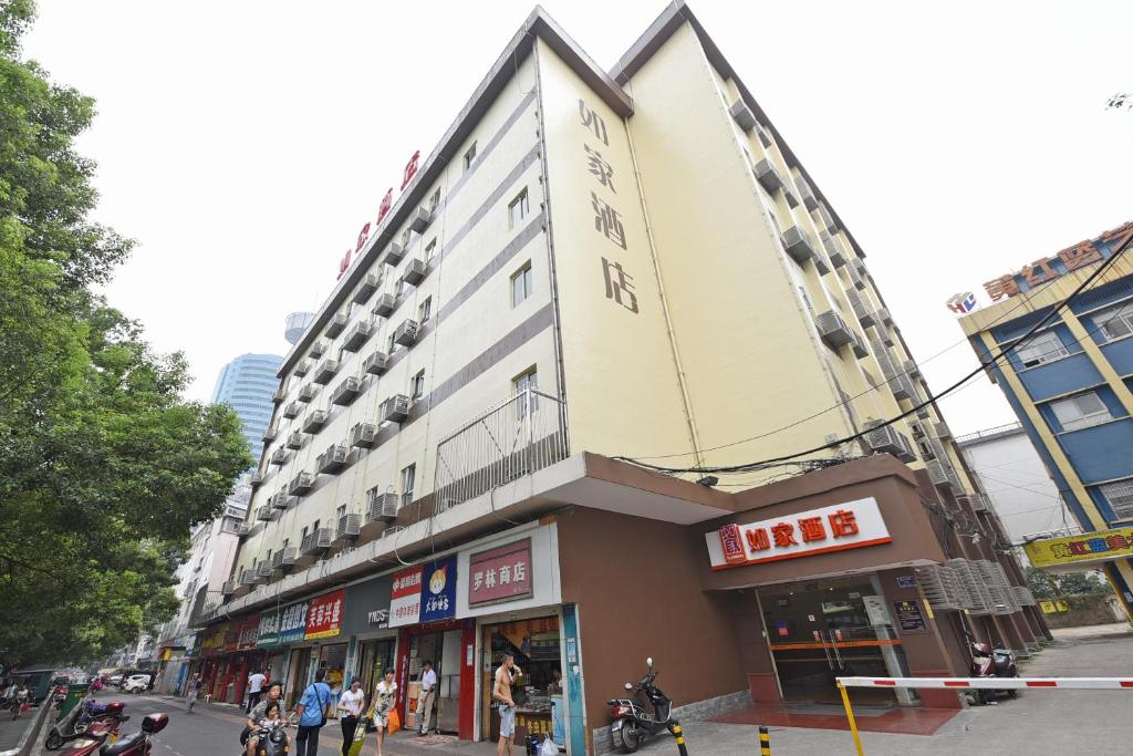 a large building on a city street with people standing outside at Home Inn Changsha North Shaoshan Road Chengnan Road in Changsha