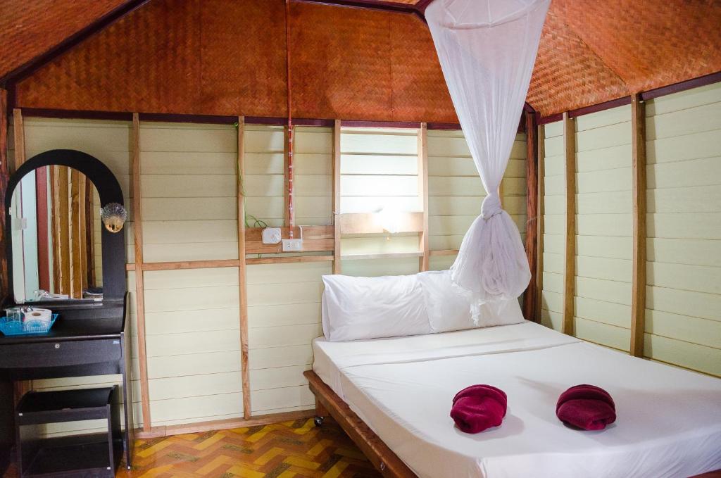 A bed or beds in a room at Nature Beach Resort, Koh Lanta