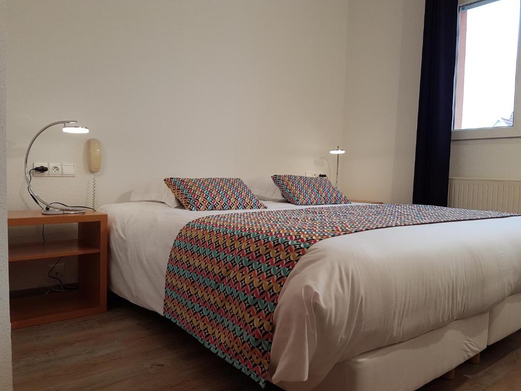 Postel nebo postele na pokoji v ubytování Hôtel Des Bois