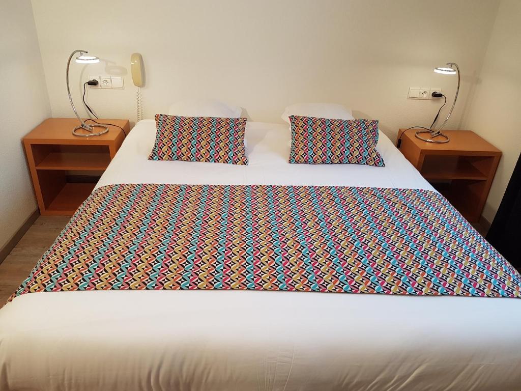 Postel nebo postele na pokoji v ubytování Hôtel Des Bois