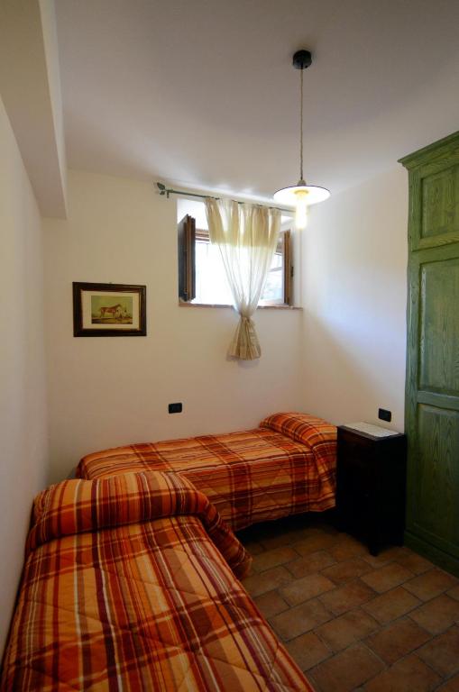 Posteľ alebo postele v izbe v ubytovaní Borgo Di Cortolla
