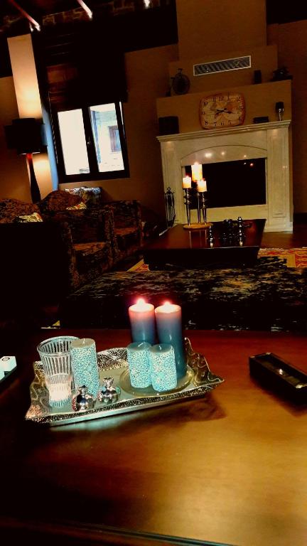 a tray with candles on a table in a living room at Grand Meteora Hotel in Kalabaka