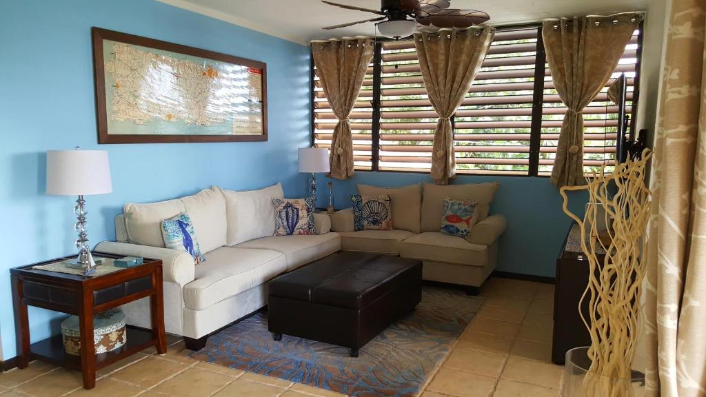 a living room with a couch and a table at Fully Air-Conditioned Beach Front Penthouse Apartment in Naguabo
