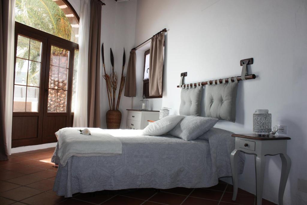 a bedroom with a bed and a window and a door at Casa Rural "La Molina" in Máguez