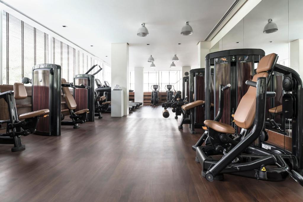 A bright fitness room equipped for resistance and cardio workouts.