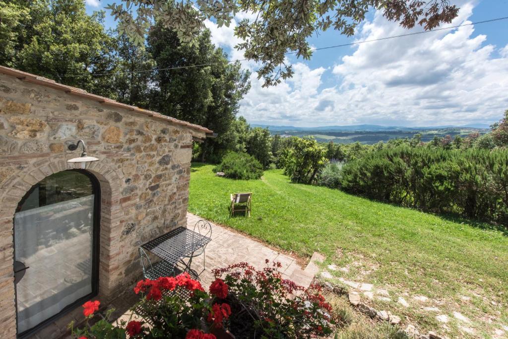 a stone house with a view at Agriturismo La Collina Dei Lecci in San Gimignano