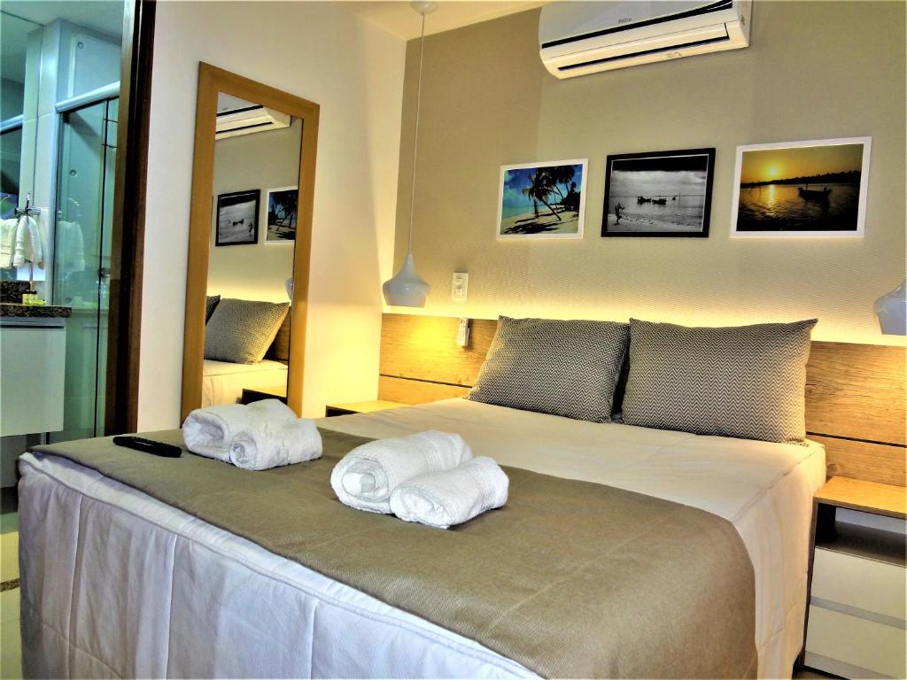 a bedroom with a bed with towels on it at Open Door Apartamentos - Maceió - Alagoas - BRA in Maceió