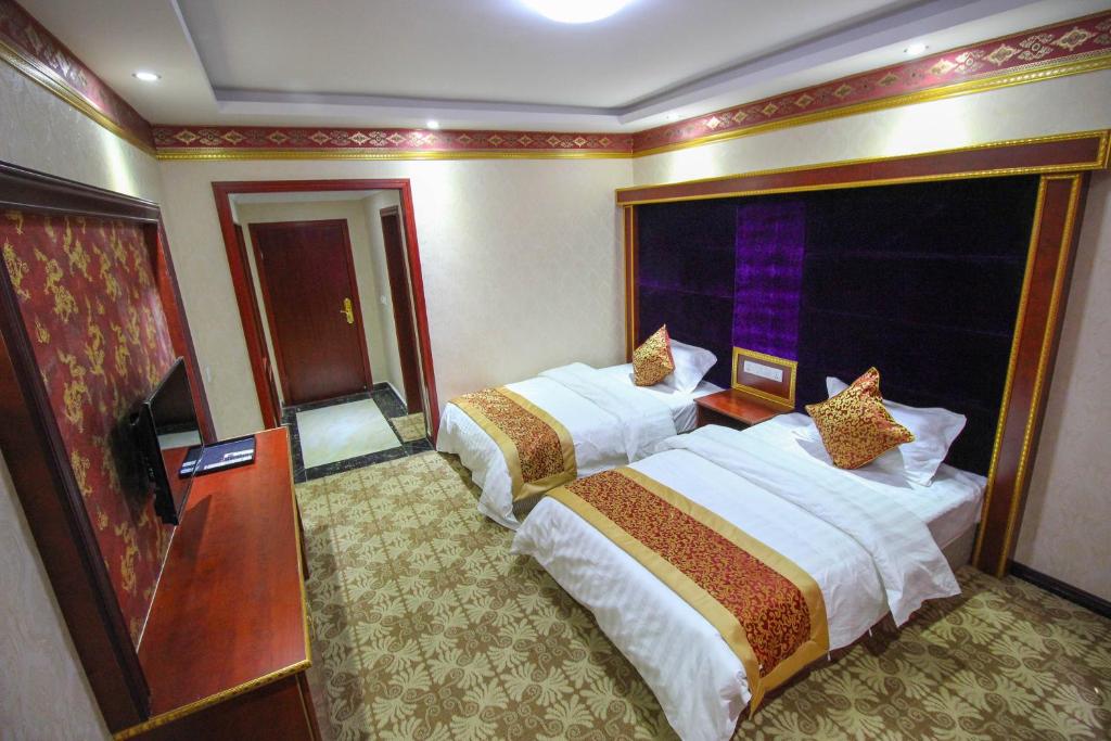 Postel nebo postele na pokoji v ubytování Jiuzhaigou Leisure Inn