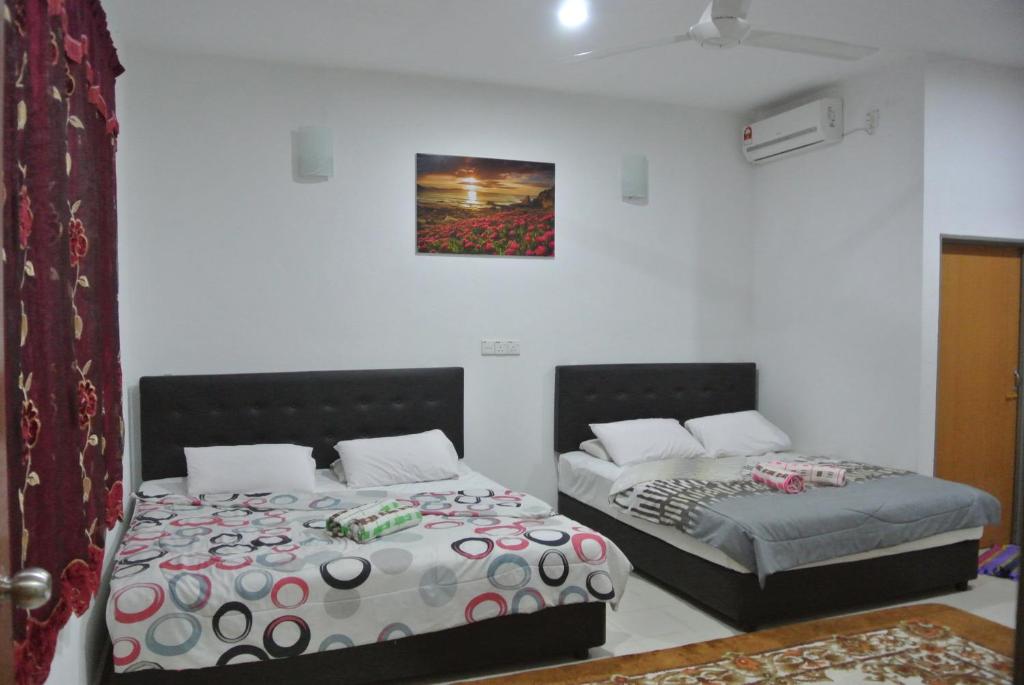 Postel nebo postele na pokoji v ubytování Wave Langkawi Inn