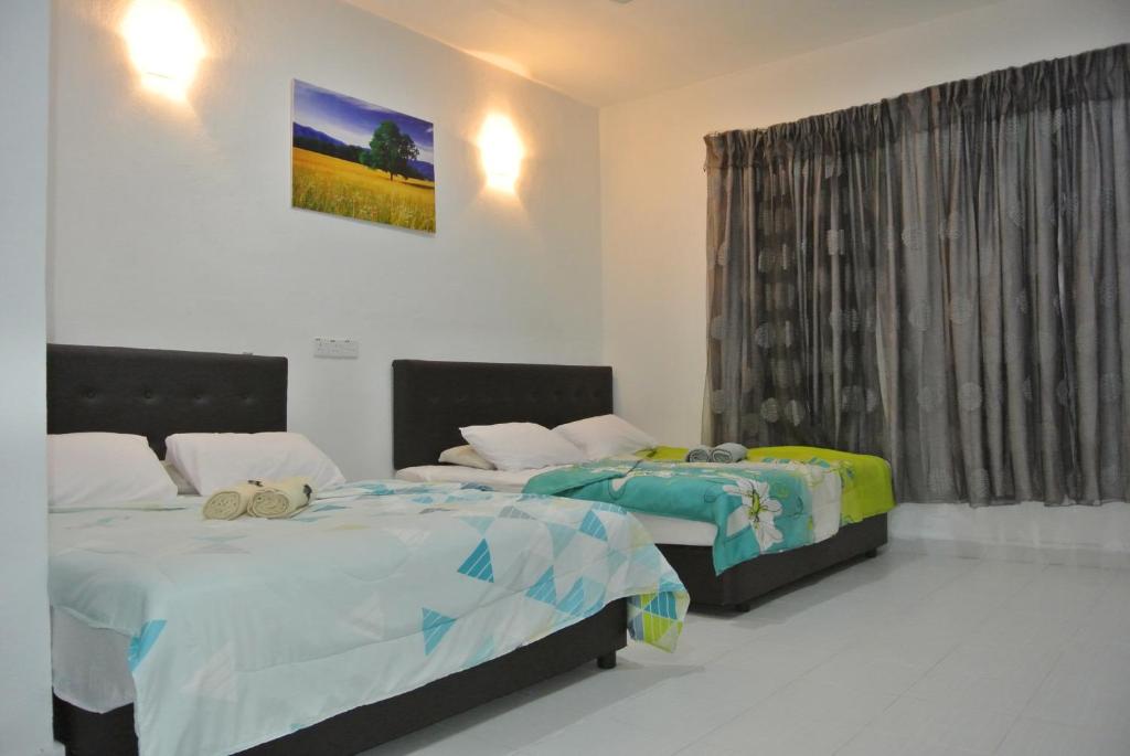 Postel nebo postele na pokoji v ubytování Wave Langkawi Inn