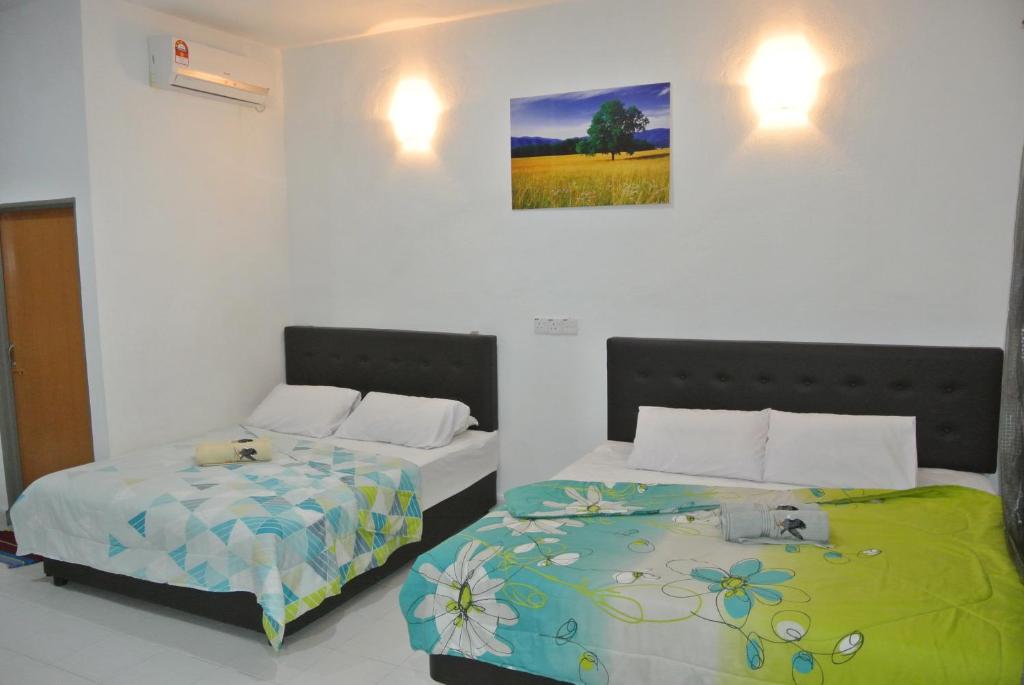 Postel nebo postele na pokoji v ubytování Wave Langkawi Inn