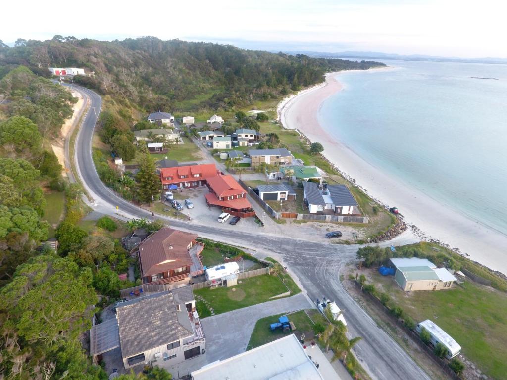 an aerial view of a beach with houses and the ocean at White Sands in Rangiputa