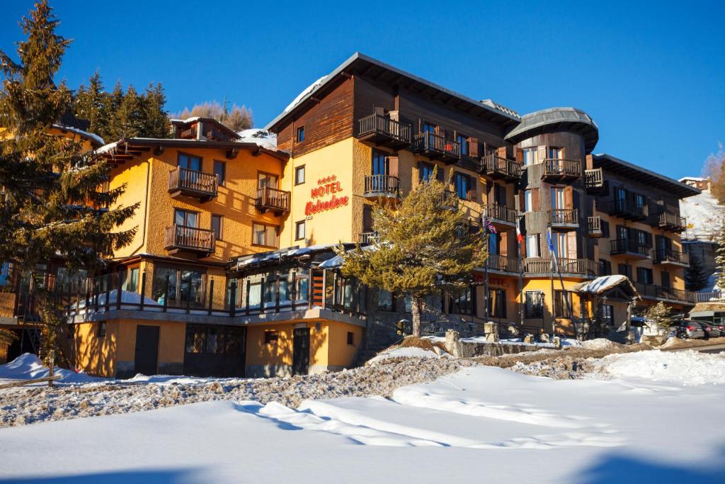 a hotel in the winter with snow on the ground at Hotel Belvedere in Sestriere