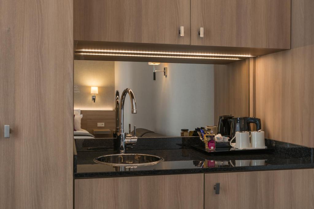 a kitchen counter with a sink and a mirror at Magda Champs Elysées in Paris