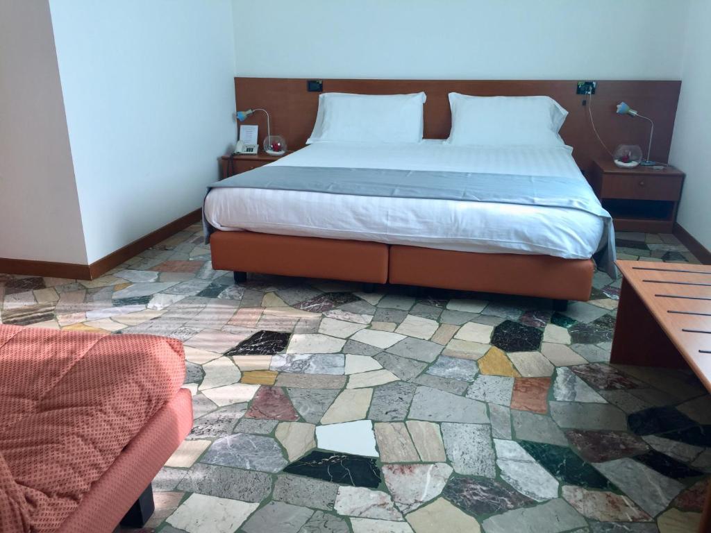 Postel nebo postele na pokoji v ubytování Albergo Isetta